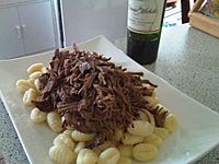 Beef and gnocchi on white dish, 2009