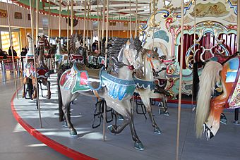 Painted wooden horses inside a carousel