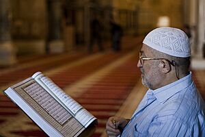 Palestinian Muslim reading The Holy Qur'an in Al-Aqsa mosque