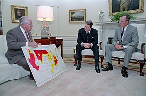 President Ronald Reagan and Vice President George H. W. Bush in the Oval Office discuss the status of the drought situation with Richard Lyng