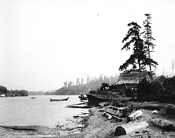 Washington edu Salmon Bay Charlie's house at Shilshole w canoe offshore, c 1905, 83.10.9067