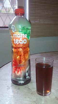 A bottle of an ice tea variataion of mate and a glass of it