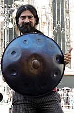 Handpan player showing handpan at cathedral, Milan, Italy.jpg