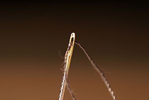 Sewing needle eye with thread