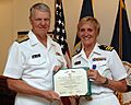 US Navy 090911-N-8273J-207 Chief of Naval Operations (CNO) Adm. Gary Roughead presents the Purple Heart medal to Cmdr. Kim LeBel for wounds received in action during her individual augmentee assignment in Afghanistan