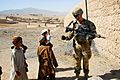 Australian Army Pvt. Levi Mooney, right, bumps fists with a child during a patrol in Tarin Kowt, Uruzgan province, Afghanistan, July 26, 2013 130726-Z-FS372-401