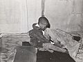 Little boy putting on his shoes. Chicago, Illinois