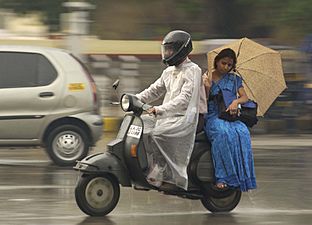 Monsoon couple on motorcycle
