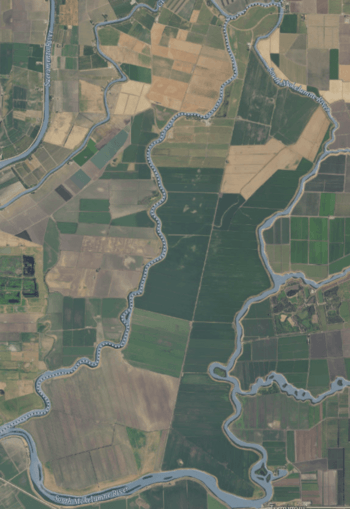 An aerial photograph of an island covered in farmland and surrounded by rivers.
