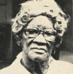 Photograph of an elderly African-American woman wearing glasses.