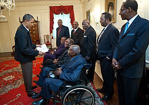 President Barack Obama talks with participants from the 1968 Memphis sanitation strike
