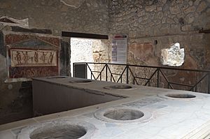 Thermopolium of Vetutius Placidus opening directly onto the south side of the Via dell'Abbondanza, Pompeii (15042641332)