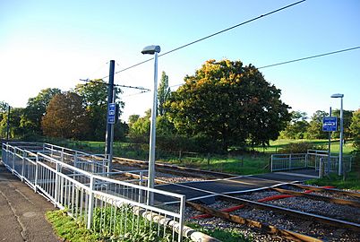 A photograph which illustrates the footpath's crossing at a London Trams' light rail tram line, at the East Croydon station.