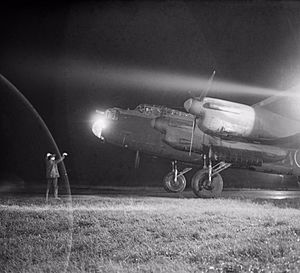 An Avro Lancaster Mk III of No. 49 Squadron RAF is guided to its dispersal point at Fiskerton, Lincolnshire, after returning from a raid on Berlin, 22 November 1943. CH11642.jpg