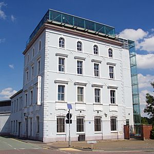 A four-storey brick building with glass rooftop extension