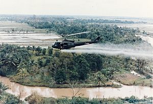 US-Huey-helicopter-spraying-Agent-Orange-in-Vietnam