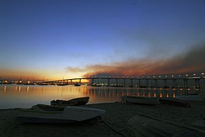 US Navy 071023-N-5491S-001 The sun rises over the Coronado Bay Bridge with smoke from the Harris fire looming overhead
