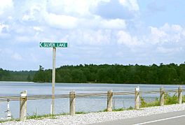 view of Silver Lake from a roadway; a roadsign with the name of the lake is in the picture