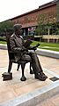 Statue of seated man reading a book