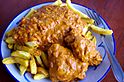 Chicken moambe with French fries (14792587921).jpg