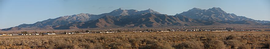 View northeast (location of west region of Peacock Mountains), east, and southeast. A panorama of the Hualapai Mountain range seen from Kingman, Arizona. The photographs were taken in late December and the mountains have a light dusting of snow. The camera location was south of Northern Avenue, east of Bank Street.