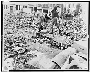 Kids in West Side lot play with debris