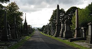 The vista westwards along the main promenade of Undercliffe Cemetery with monuments to either side and the Joseph Smith obelisk in the far distance