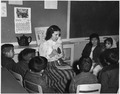 (Teacher with picture cards giving English instruction to Navajo day school students.) - NARA - 295158