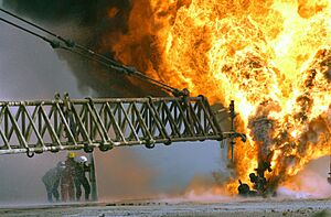 US Navy 030328-M-0000X-005 Kuwaiti firefighters fight to secure a burning oil well in the Rumaila oilfields