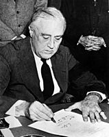 Franklin Roosevelt signing declaration of war against Japan