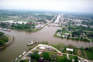 Aerial view of Larose at the intersection of Bayou Lafourche and the Gulf Intracoastal Waterway. View is to the east-southeast. The bayou runs off towards the Gulf of Mexico at the top. The waterway crosses the picture left–right.