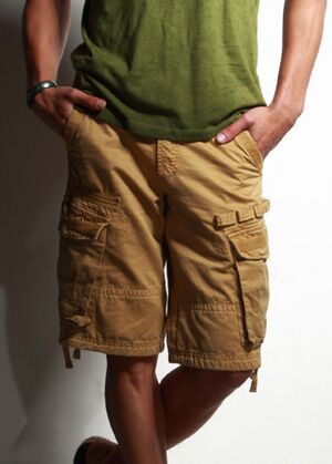Man wearing a green T-shirt and cargo shorts (cropped)