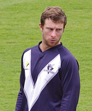 A waist up photograph of a cricketer in a training top