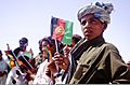 Afghan children wave flags during a celebration of the Islamic religious holiday of Eid al-Fitr in the Garmsir district of Helmand province, Afghanistan, Aug 110831-M-ED643-010
