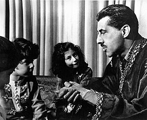IDRIES SHAH TELLING A STORY TO HIS CHILDREN, TAHIR, SAFIA, AND SAIRA SHAH