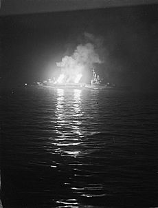 The cruiser HMS Belfast bombarding German positions in Normandy