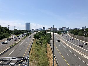 2019-06-28 12 14 48 View south along Interstate 495 (Capital Beltway) from the overpass for Virginia State Route 694 (Lewinsville Road) in Mclean, Fairfax County, Virginia, with the skyline of Tysons Corner visible in the distance