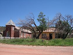 Church and its deteriorated rectory in Cuervo