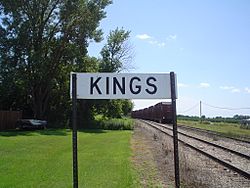 Sign along the railroad tracks for Kings