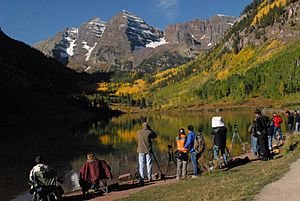 Maroon Bells, two peaks in the Elk Mountains that are less than half-mile apart, are reflected on Maroon Lake