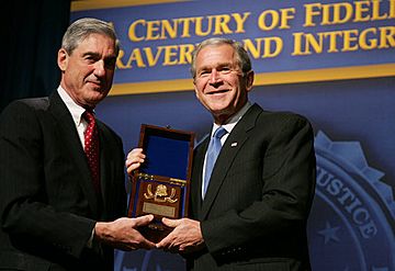 President George W. Bush is presented with an honorary FBI Special Agent credential by FBI Director Robert Mueller