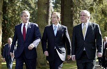 President George W. Bush walks with British Prime Minister Tony Blair and Irish Prime Minister Bertie Ahern at Hillsborough Castle as he prepares to depart Northern Ireland