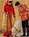 Traditional dressed bride and groom with Alabay dog