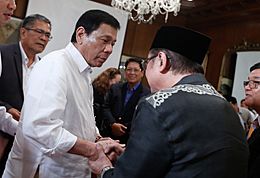 President Rodrigo Duterte is greeted by Mindanao Development Authority Chairperson Abul Khayr Alonto