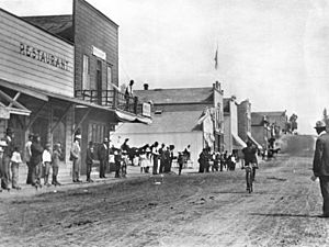 Spectators watching a bicyclist on Beacon Street, San Pedro, ca.1907 (CHS-4783)