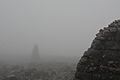 Summit cairn on Ben Nevis in thick fog