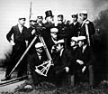  Uniformed group poses with theodolites, level staves and octant. 