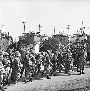 Men of the 2nd Seaforth Highlanders embarking onto landing craft at Sousse, Tunisia, en route for Sicily, 5 July 1943. NA4072
