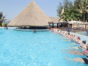 People tourists in swimming pool hotel Gambia
