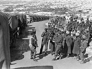 Indian soldiers stand next to a supply convoy en route to the Soviet Union